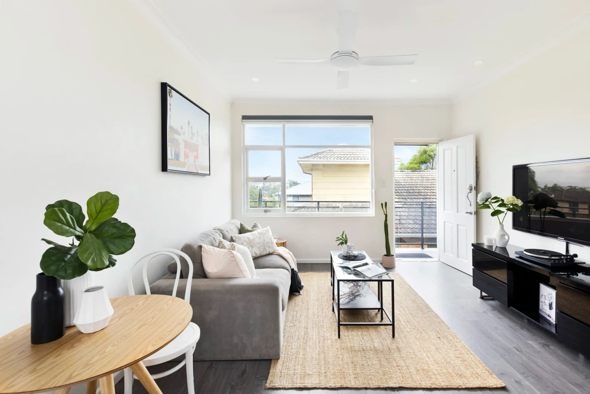 Bright living room with a dining table, opening onto a small balcony, Freshwater