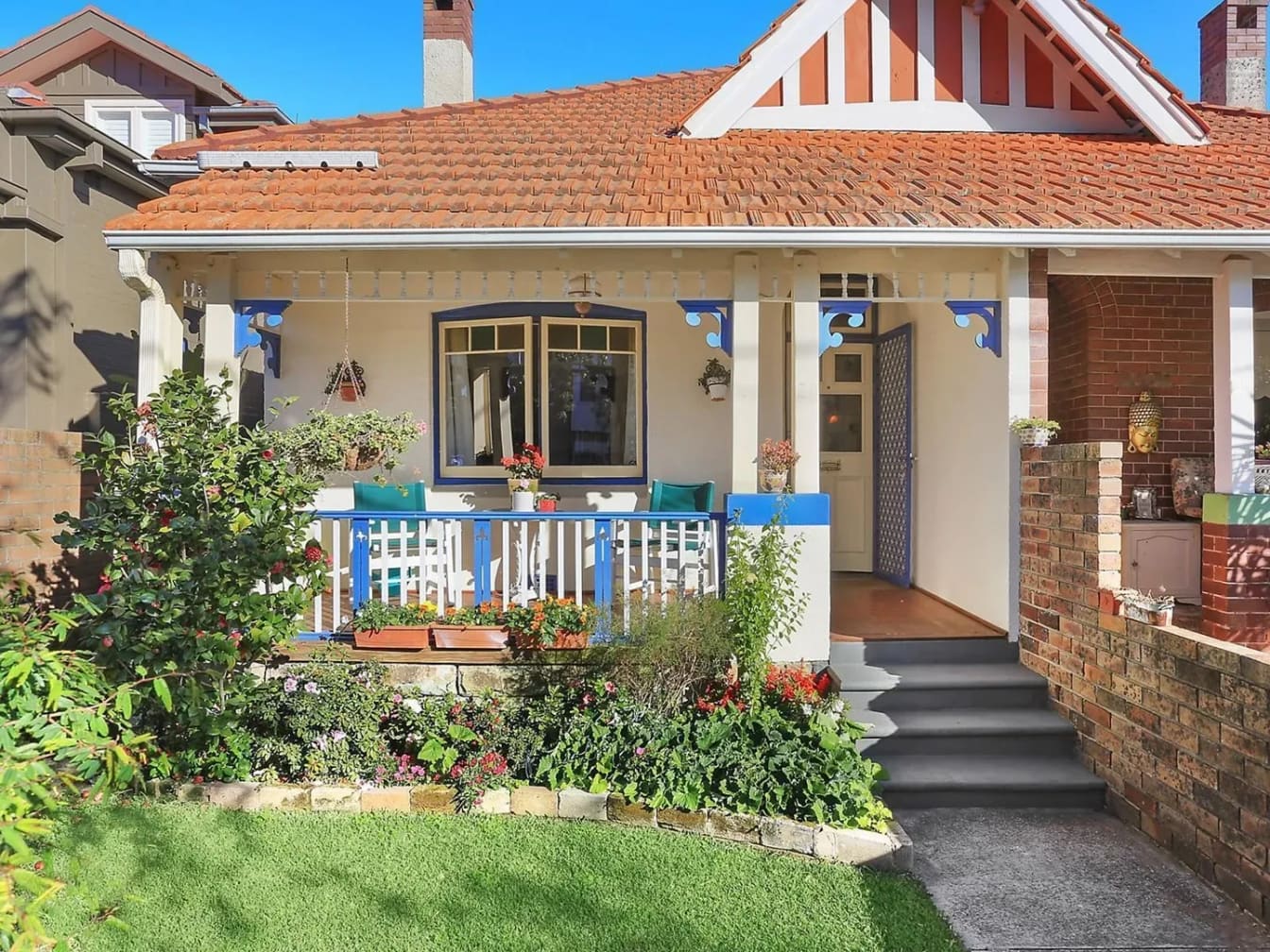 Federation bungalow with a terracotta roof and blue verandah trim, Manly
