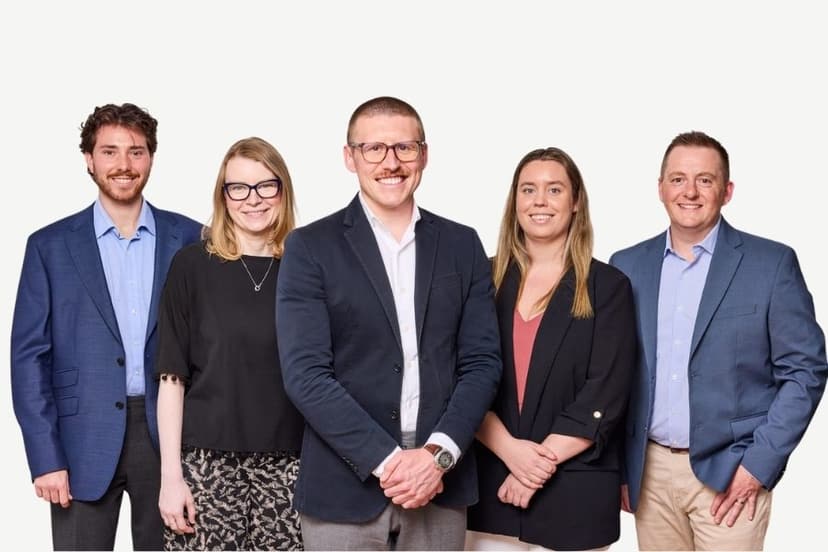 The five-person STRAND team, standing together.